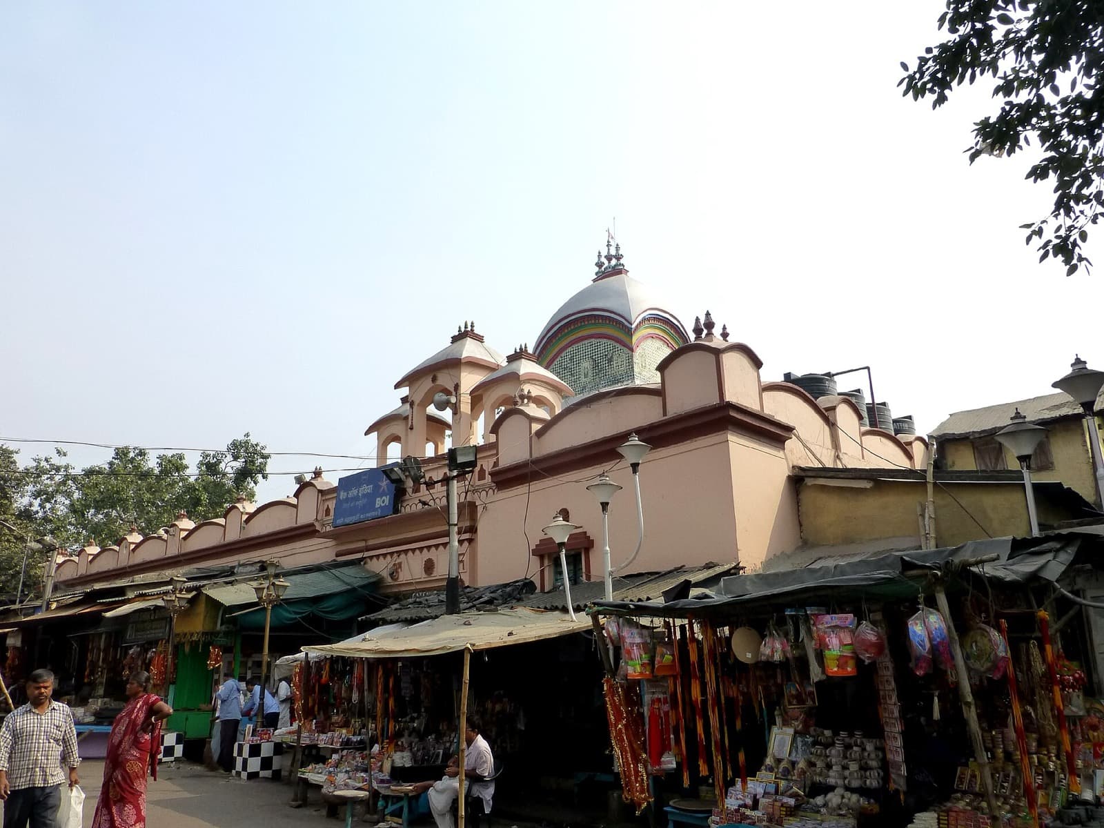 Kalighat temple dome rising above bazaar stalls in Kolkata