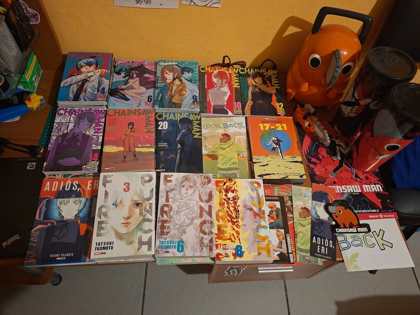 Tatsuki Fujimoto manga volumes including Look Back, Chainsaw Man and Fire Punch on a shelf