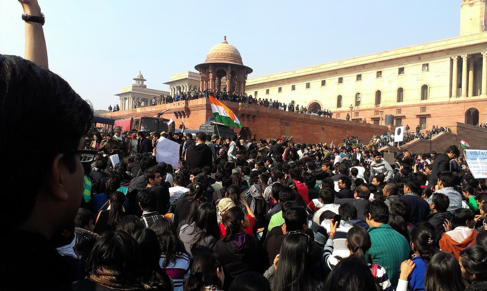Large crowd of protesters with an Indian flag outside the Secretariat in Delhi