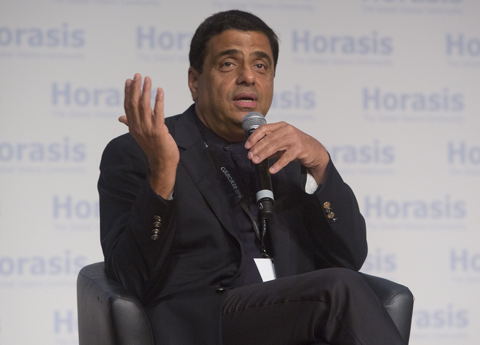 Ronnie Screwvala speaking into a microphone on a conference stage