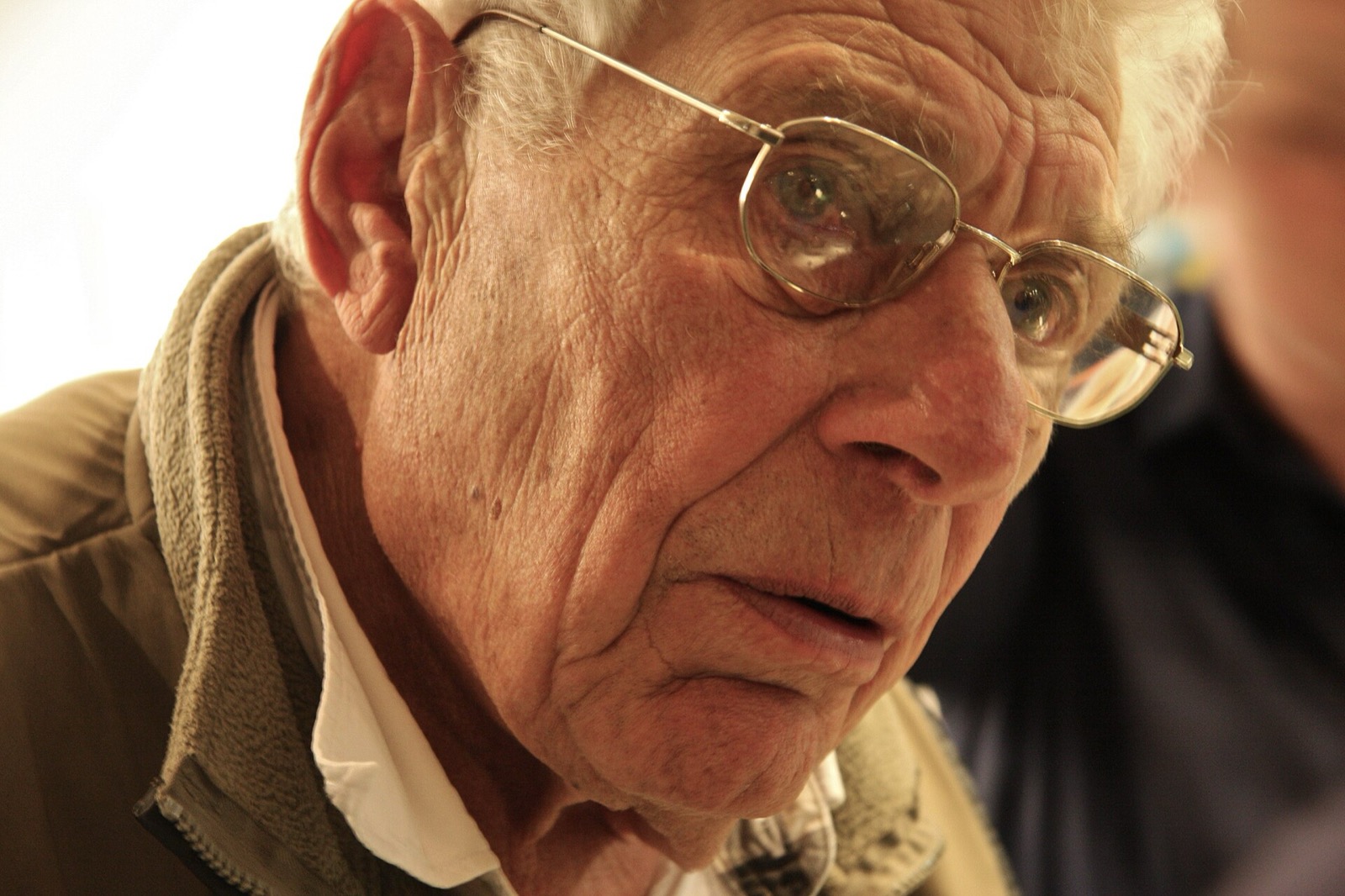White-haired John Berger speaking at a London event