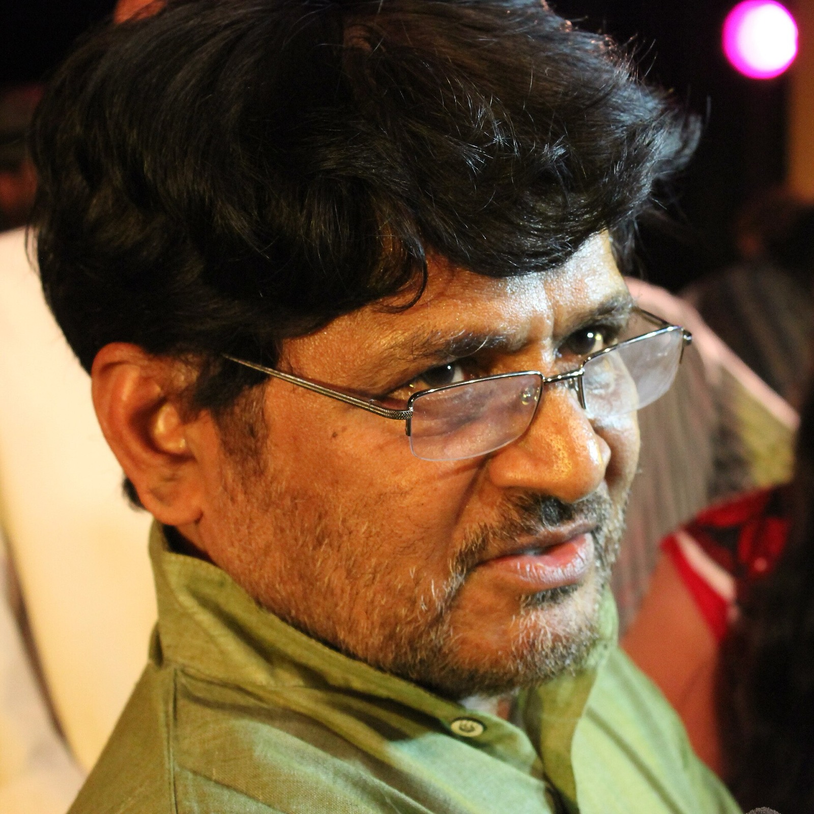 Close portrait of actor Raghubir Yadav wearing glasses