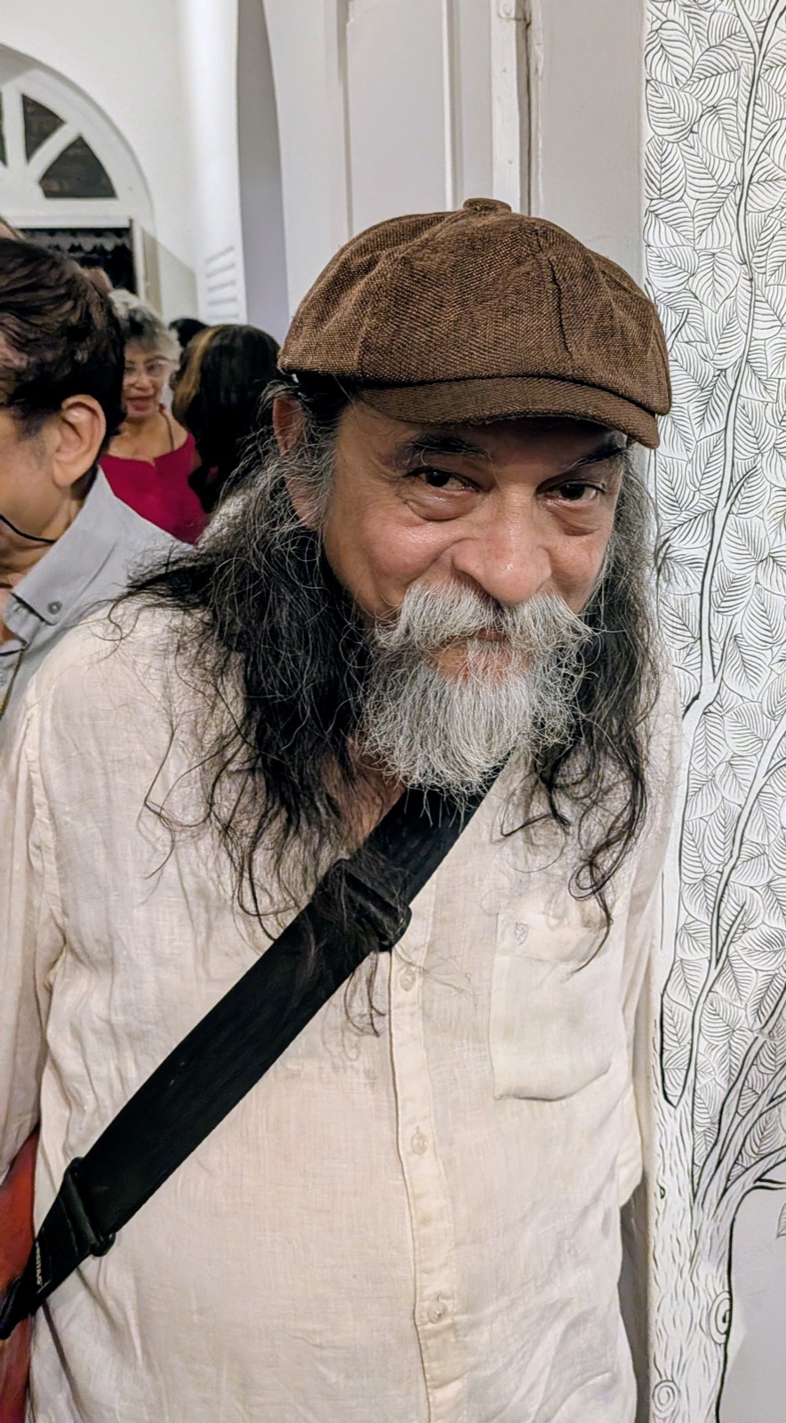 Portrait of graphic novelist Orijit Sen in a brown cap
