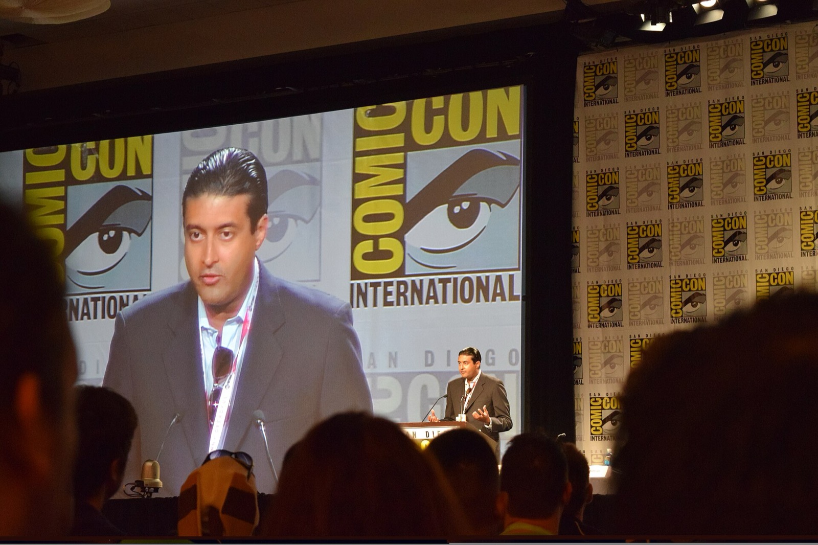 Sharad Devarajan speaking on stage at a Comic-Con panel