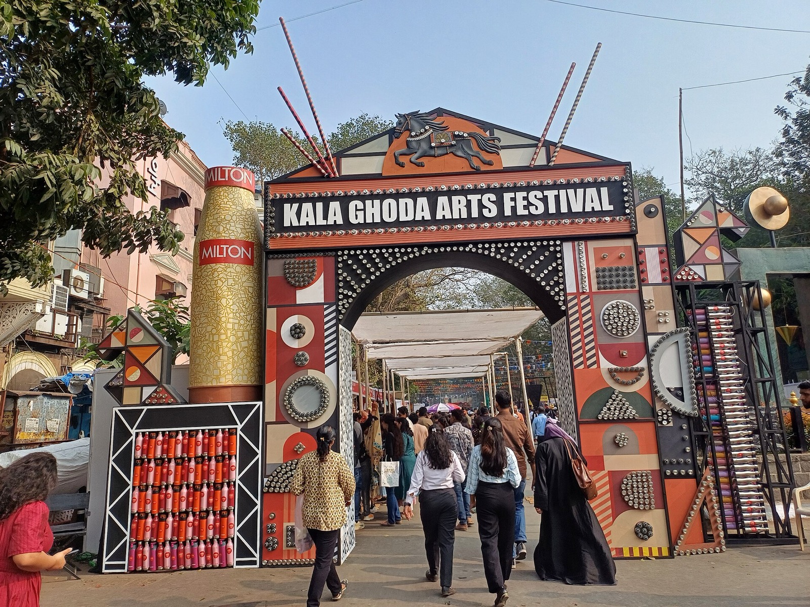Decorated entrance arch of the Kala Ghoda Arts Festival with visitors walking through