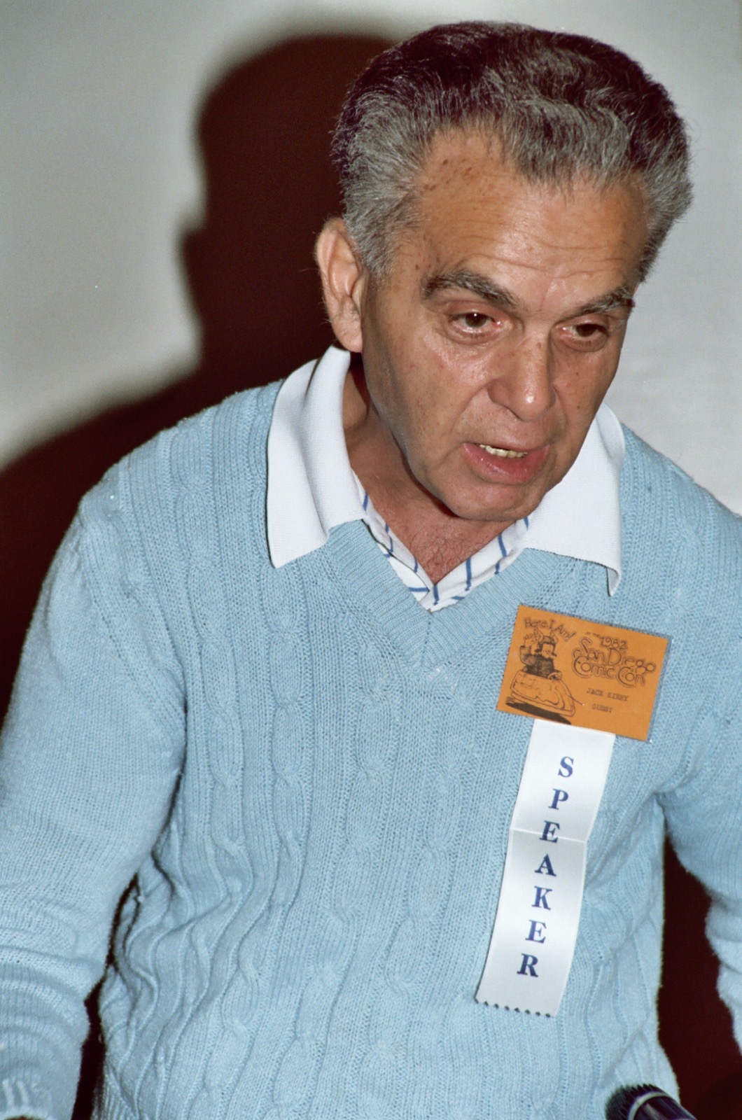 Jack Kirby smiling at a table at the 1982 San Diego Comic-Con