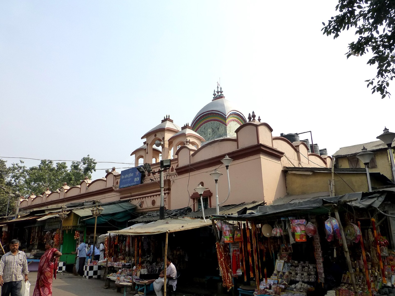 Kalighat temple dome rising above bazaar stalls in Kolkata