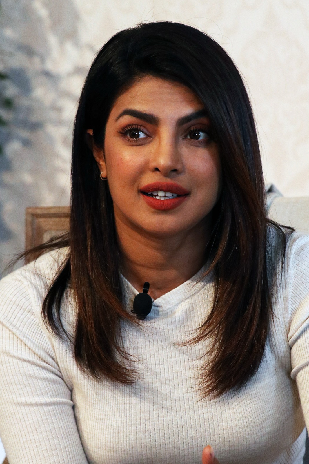 Priyanka Chopra in a white top speaking during a panel discussion