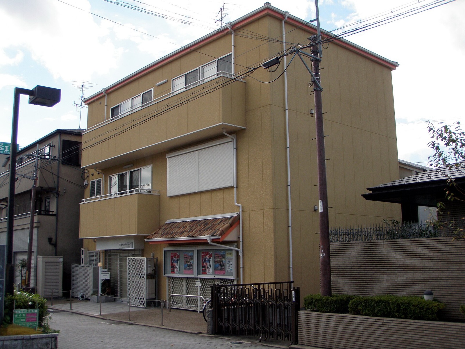 Three-story mustard-yellow office building of Kyoto Animation