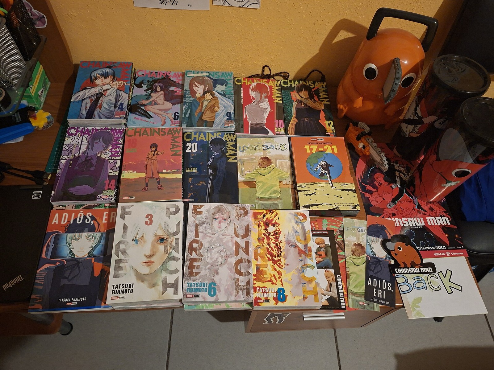 Tatsuki Fujimoto manga volumes including Look Back, Chainsaw Man and Fire Punch on a shelf