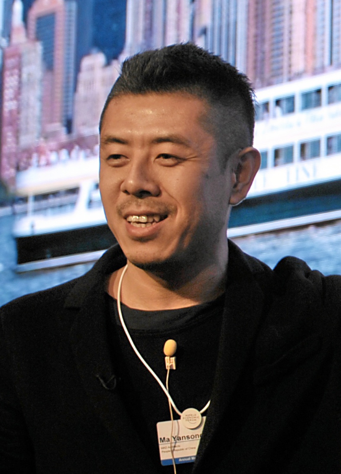 Ma Yansong smiling with a lapel microphone at the World Economic Forum