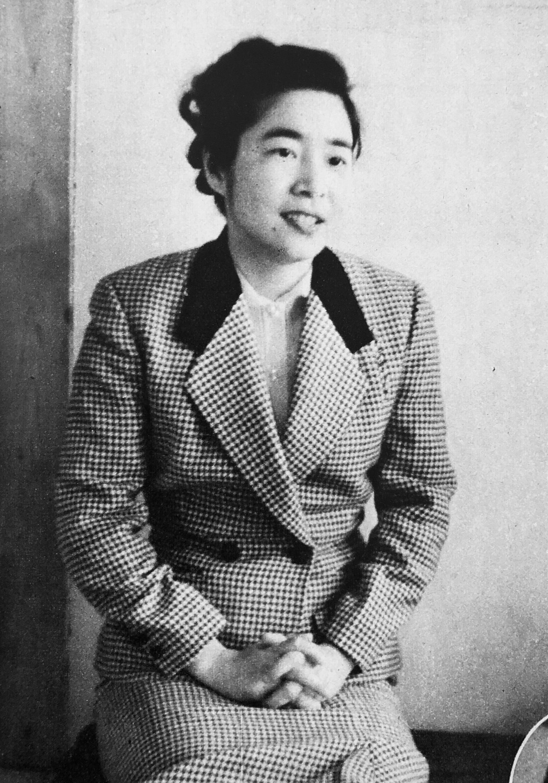Black and white portrait of Machiko Hasegawa seated in a checked jacket