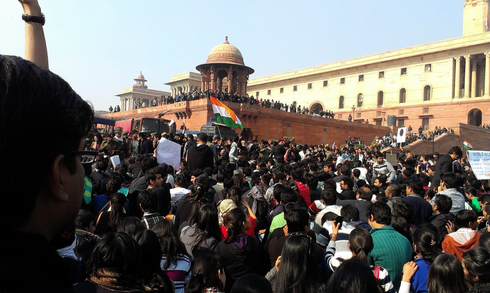 Large crowd of protesters with an Indian flag outside the Secretariat in Delhi