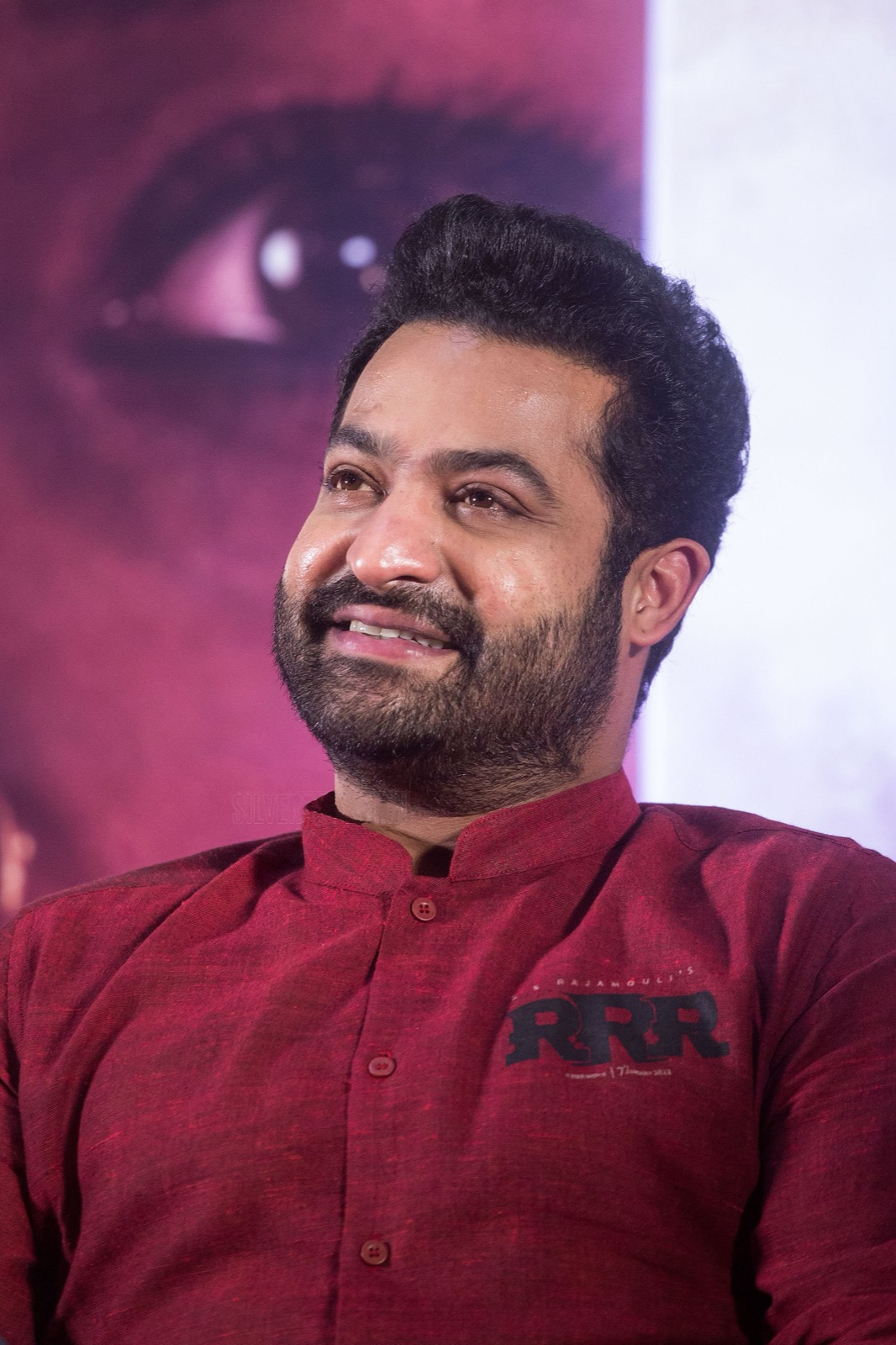 N. T. Rama Rao Jr. smiling in a maroon RRR kurta at a press event