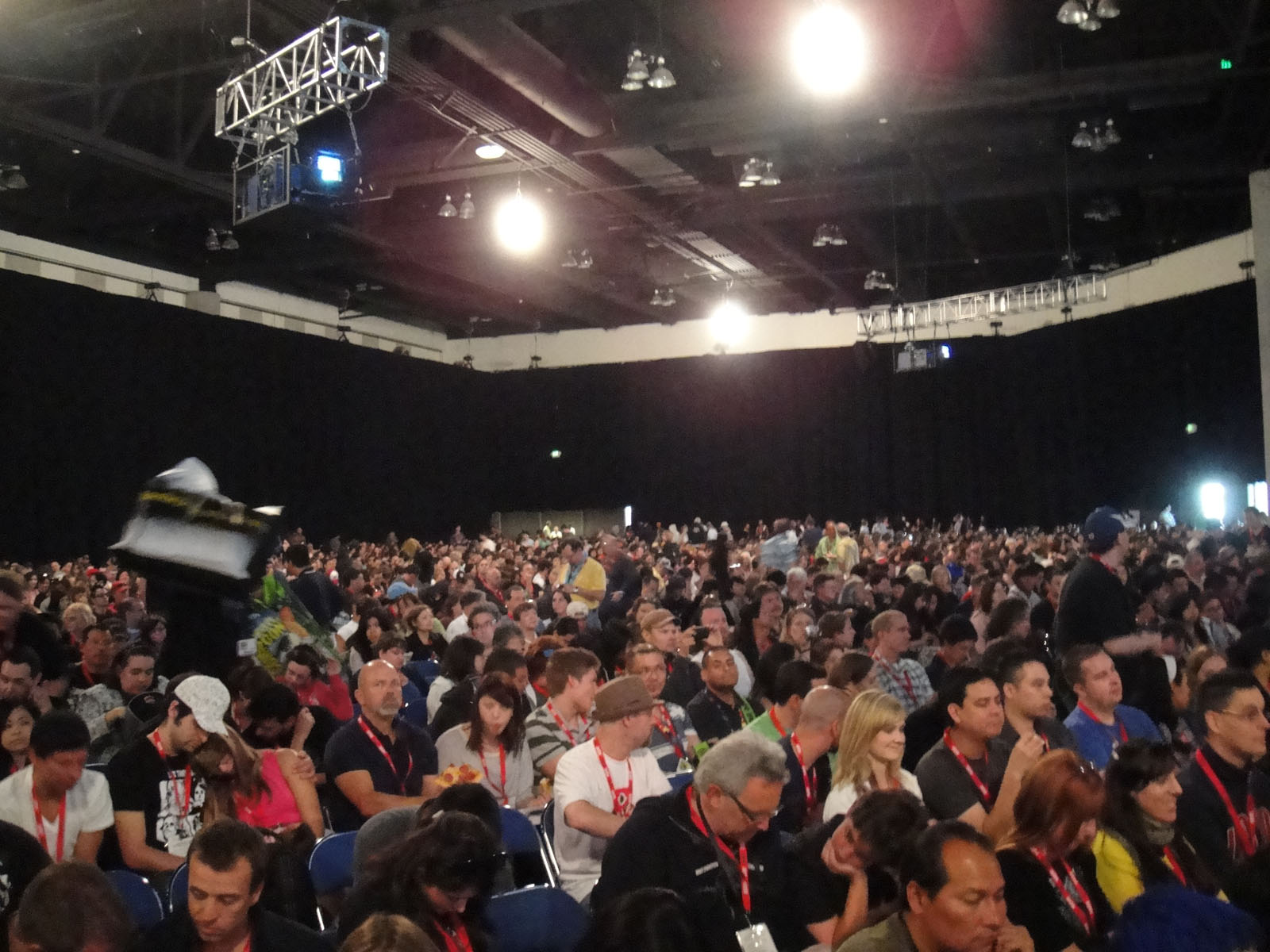 Thousands of badge-wearing attendees seated inside the darkened Hall H at Comic-Con