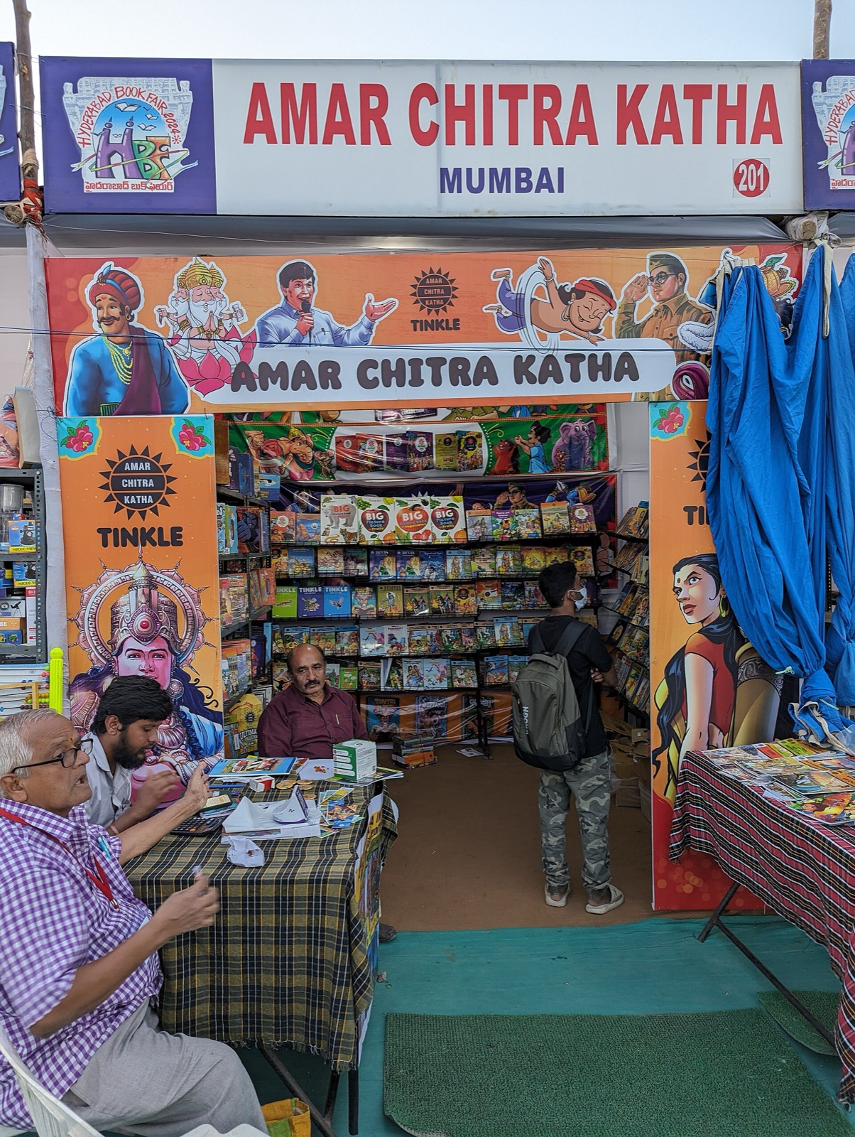 Book fair stall signed Amar Chitra Katha and Tinkle stacked with comics