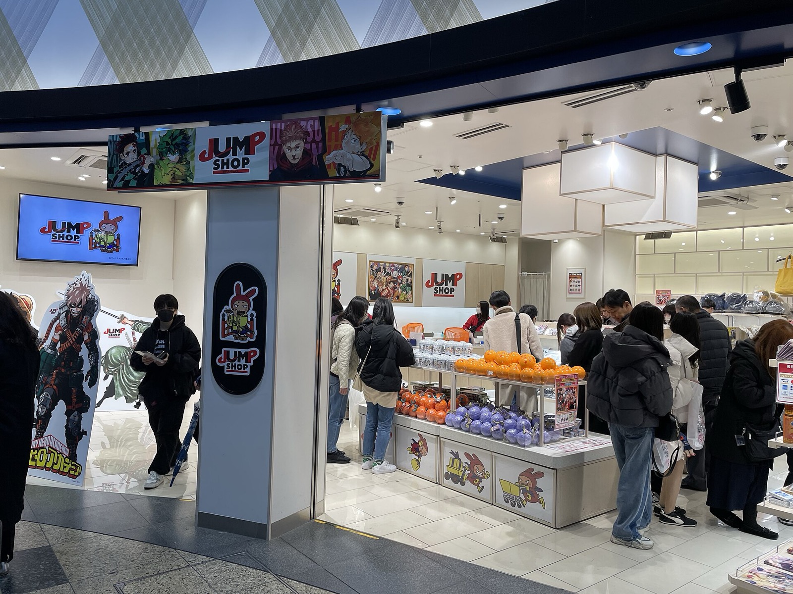 Shoppers crowd a Jump Shop store entrance decorated with Jump character banners